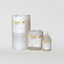 Three containers of AMS concentrated caustic in different sizes, placed against a white background.